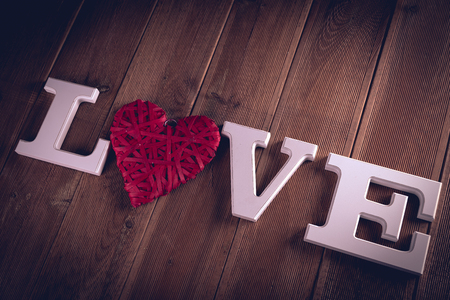 Valentine concept on wooden table with white lettersの写真素材