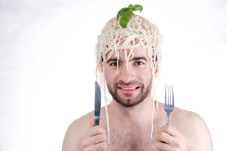 Funny man with spaghetti on head, white backgroundの写真素材