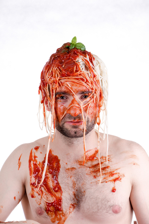 Funny man with spaghetti on head, white backgroundの写真素材