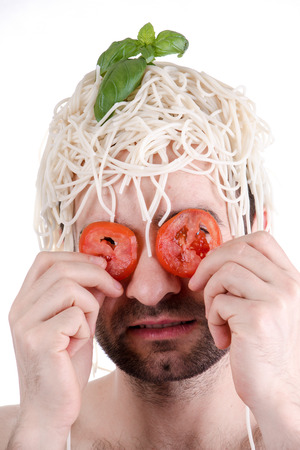 Funny man with spaghetti on head, white backgroundの写真素材