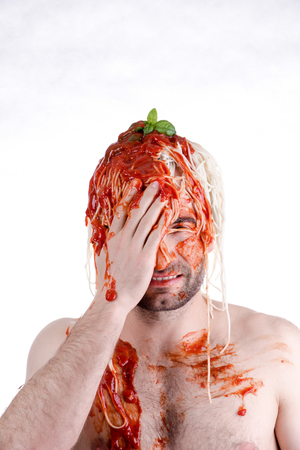 Funny man with spaghetti on head, white backgroundの写真素材