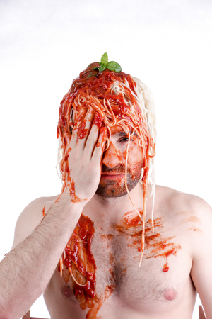 Funny man with spaghetti on head, white backgroundの写真素材