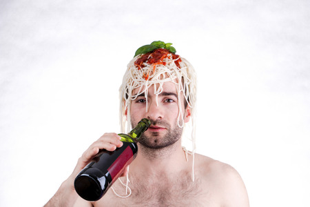 Funny man with spaghetti on head, white backgroundの写真素材