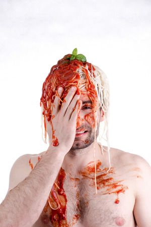 Funny man with spaghetti on head, white backgroundの写真素材