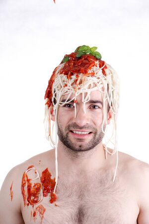 Funny man with spaghetti on head, white backgroundの写真素材