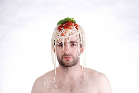 Funny man with spaghetti on head, white backgroundの写真素材