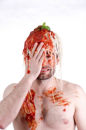 Funny man with spaghetti on head, white backgroundの写真素材