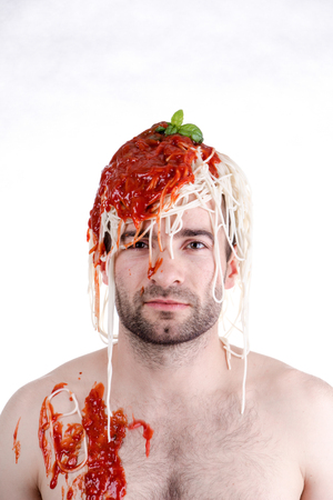 Funny man with spaghetti on head, white backgroundの写真素材