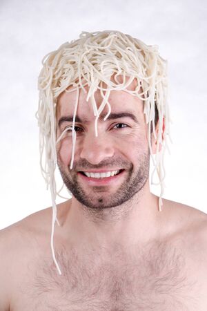 Funny man with spaghetti on head, white backgroundの写真素材