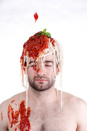 Funny man with spaghetti on head, white backgroundの写真素材