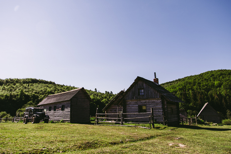 Old wooden village in natural surrounding with blue skyの写真素材
