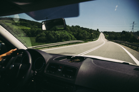 Vintage scene of driving car on road, vacations faded conceptの写真素材