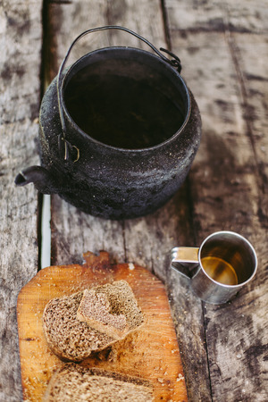 Bread and tea in metal teapot , gray vintage decks backgroundの写真素材