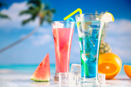 Set of exotic drinks on the beach with blue ocean backgroundの写真素材