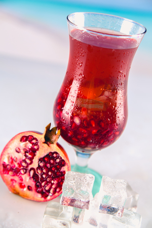Cold tasty drink on a beach with palms in backgroundの写真素材