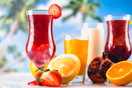 Set of exotic drinks on the beach with blue ocean backgroundの写真素材