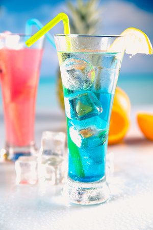 Set of exotic drinks on the beach with blue ocean backgroundの写真素材