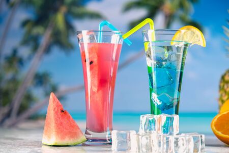 Set of exotic drinks on the beach with blue ocean backgroundの写真素材