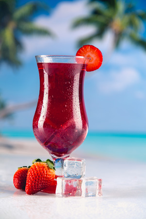 Colorful red cold drink on a beach, summer backgroundの写真素材
