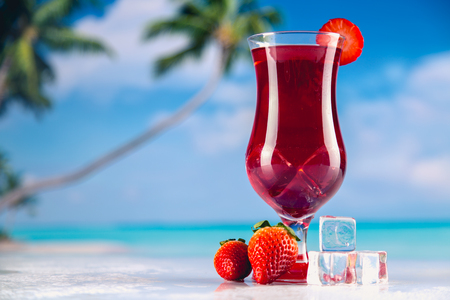 Colorful red cold drink on a beach, summer backgroundの写真素材