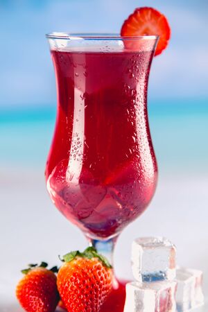 Colorful red cold drink on a beach, summer backgroundの写真素材