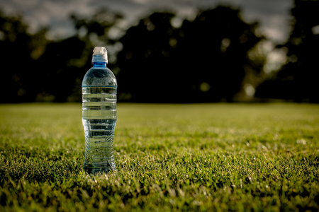 Water after running on green grass filedの写真素材