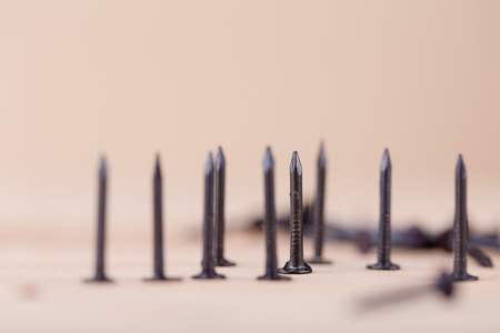 Nails on wooden table, tools and construction conceptの写真素材