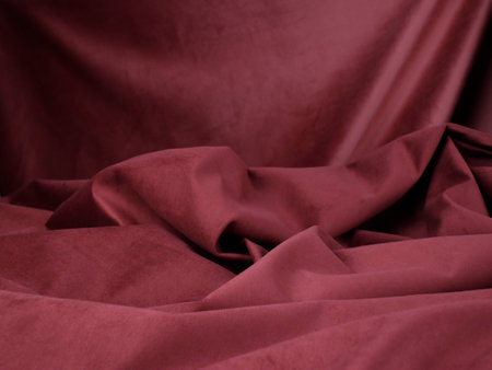Rich texture in the folds of dusty red velor.の写真素材