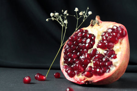 Pomegranate with seeds on a black backgroundの写真素材