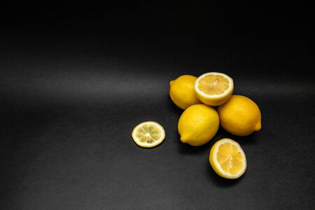 Whole lemons, slices and halves of lemons isolated on black backgroundの写真素材