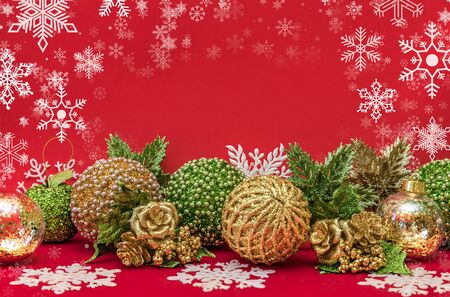 Golden, white and green Christmas decoration on red backgroundの写真素材