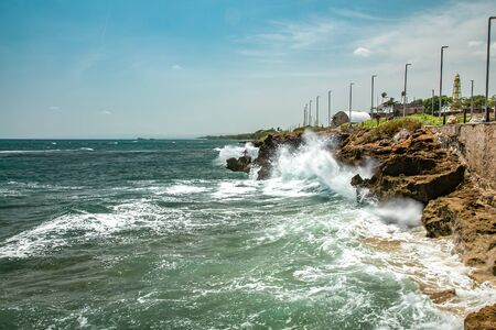 Ocean foamy waves, splashes and rocks at a quay, puerto plata, dominican republicの写真素材