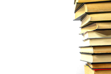 Stack of books on a white background. The books are on top of each other close-up. Side view.の写真素材