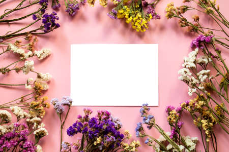Flower composition. Frame made of dried multi-colored flowers. Flat lay, top view with place for text.の写真素材