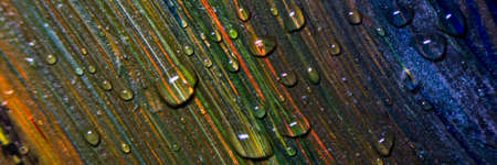 Banner Colorful multicolored paint covered with water drops, theme wallpaper background. Multicolor abstraction. Fantastic hypnotic surface. Abstract pattern close-up, texture liquid paint movement with water drops. Selective focus.の写真素材