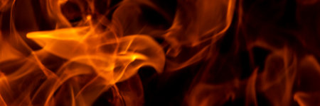 Abstract flame, banner, fire flame texture, background. Blurred moving tongues of fire on a dark...