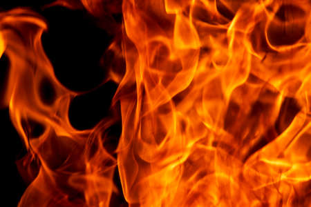 Abstract flame, fire flame texture, background. Blurred moving tongues of fire on a dark background.