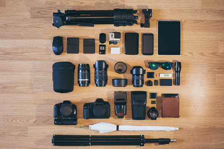 Professional photo camera is neatly folded on wood surfaceの写真素材