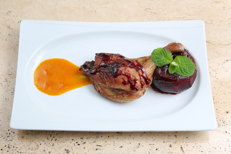 Roasted duck leg baked with apple in red wineの写真素材