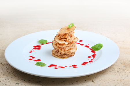 Pieces of roasted meat with pear chipsの写真素材