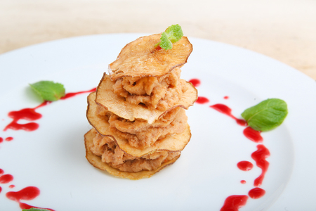 Pieces of roasted meat with pear chipsの写真素材