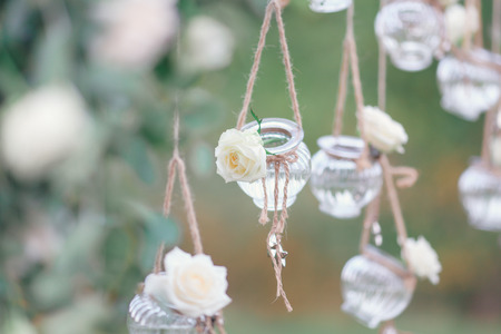 Original wedding floral decoration in the form of mini-vases and bouquets of flowers hanging from the ceilingの写真素材