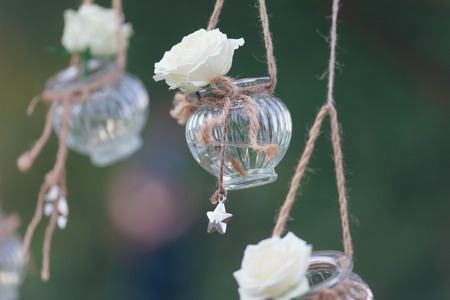 Original wedding floral decoration in the form of mini-vases and bouquets of flowers hanging from the ceilingの写真素材