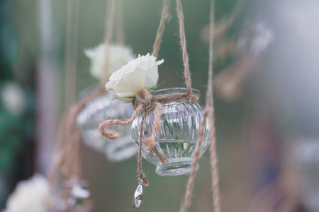 Original wedding floral decoration in the form of mini-vases and bouquets of flowers hanging from the ceilingの写真素材