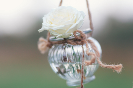 Original wedding floral decoration in the form of mini-vases and bouquets of flowers hanging from the ceilingの写真素材