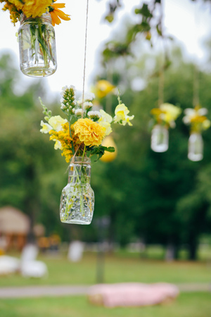 Original wedding floral decoration in the form of mini-vases and bouquets of flowers hanging from the ceilingの写真素材