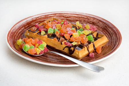 Plate of belgian waffles with cream, candied and chocolateの写真素材