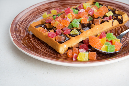 Plate of belgian waffles with cream, candied and chocolateの写真素材