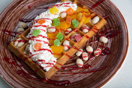 Plate of belgian waffles with cream and candiedの写真素材