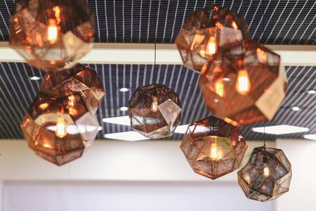 Industrial pendant lamps against rough wall. Loft interior. Edison bulbsの写真素材